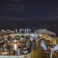 Crew introduction during festive barbecue dinner on sun deck of river cruise ship Anawrahta (Heritage Line) on Ayeyarwady (Irrawaddy) river at night, Old Bagan, Nyaung-U, Mandalay Region, Myanmar